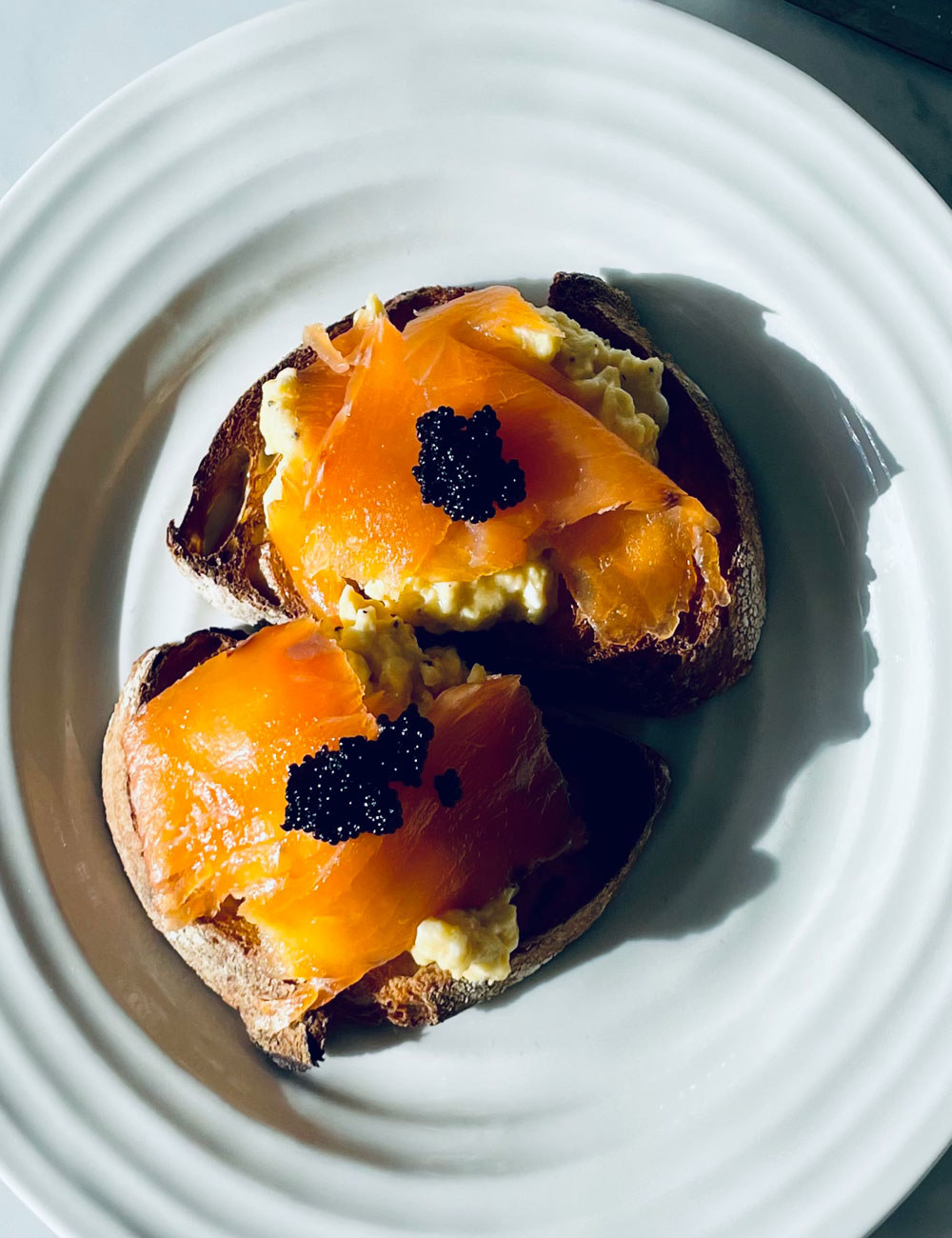 Caviar on smoked salmon and eggs with toast.
