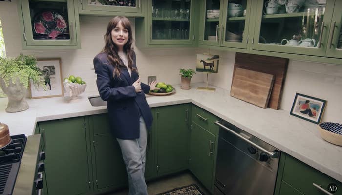 Dakota leans on her counter and points to a bowl of limes