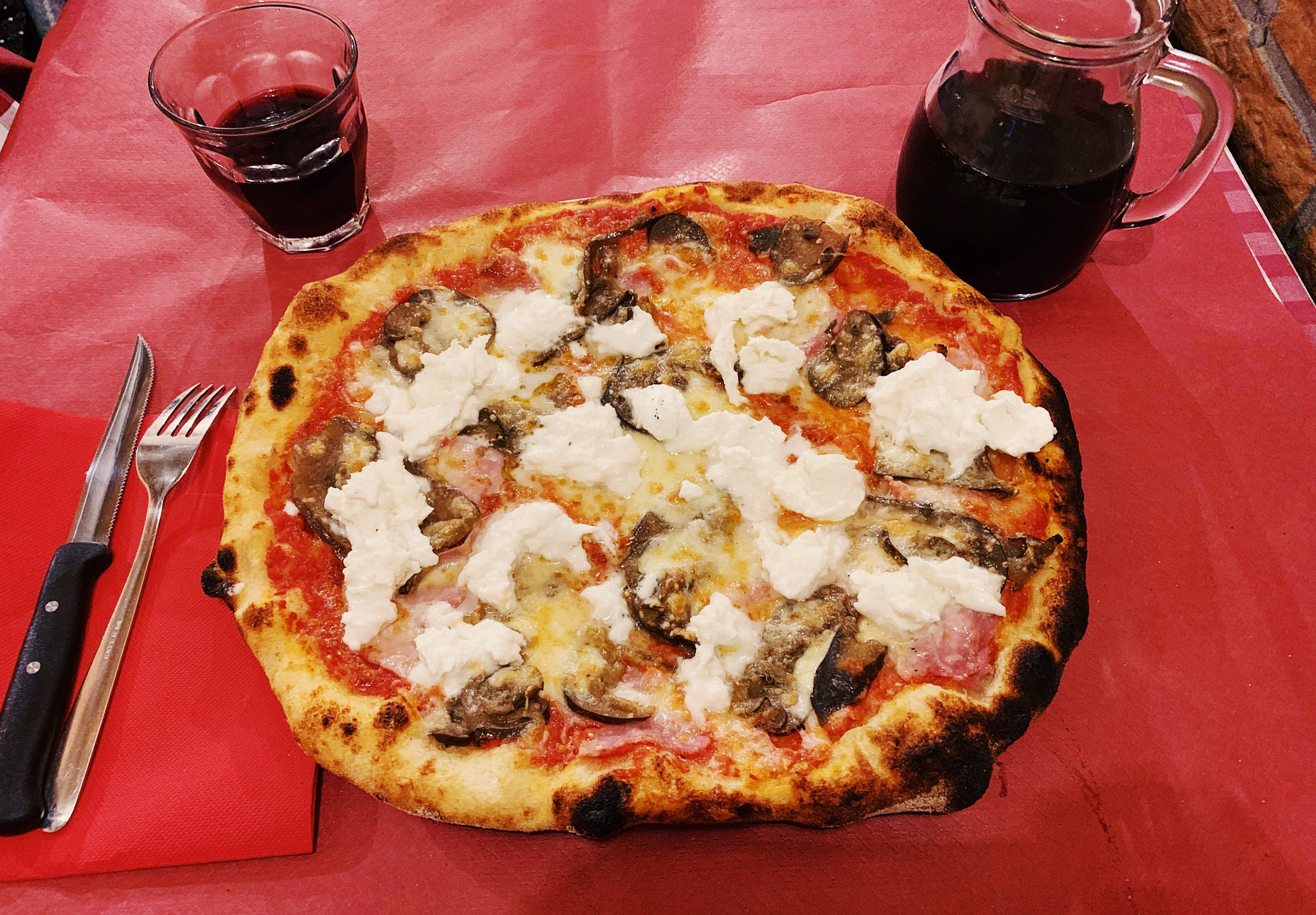 Close up of Italian pizza and red house wine