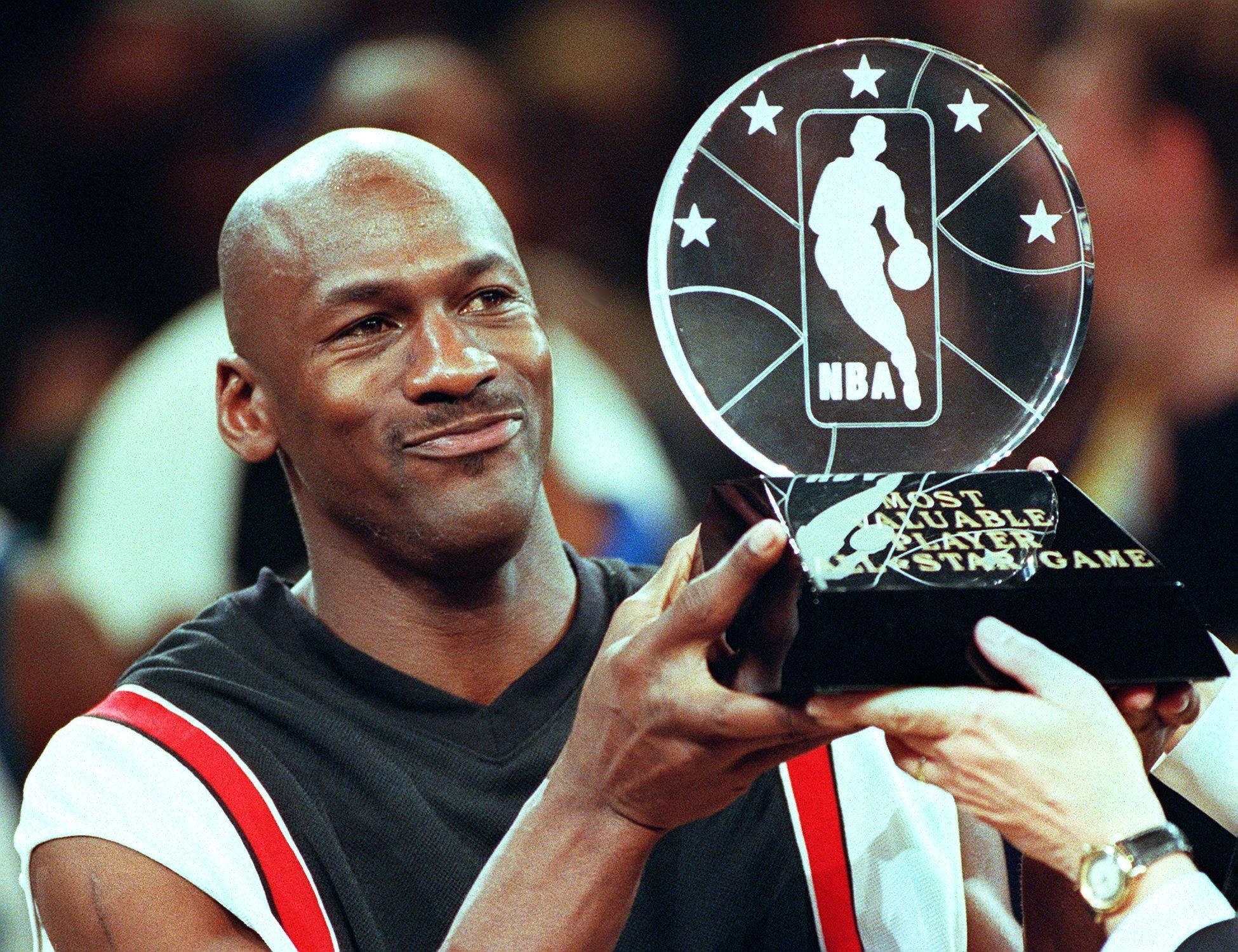 Jordan holding up the MVP award at the NBA All-Star Game in 1998