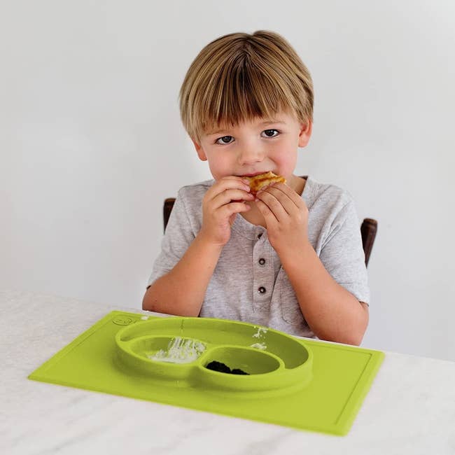 kid eating off of stick on plate