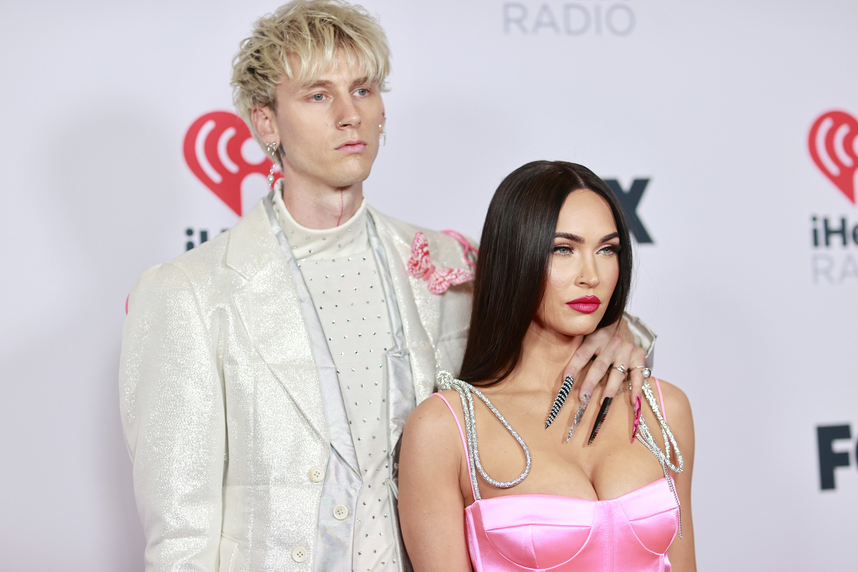 Machine Gun Kelly and Megan Fox stand next to each other at an event