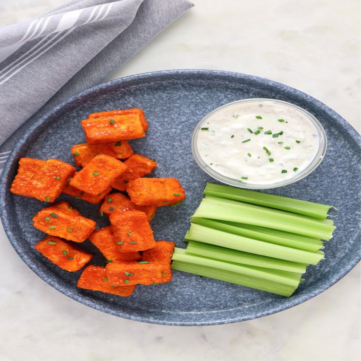 Air fryer buffalo tofu with celery and dipping sauce.