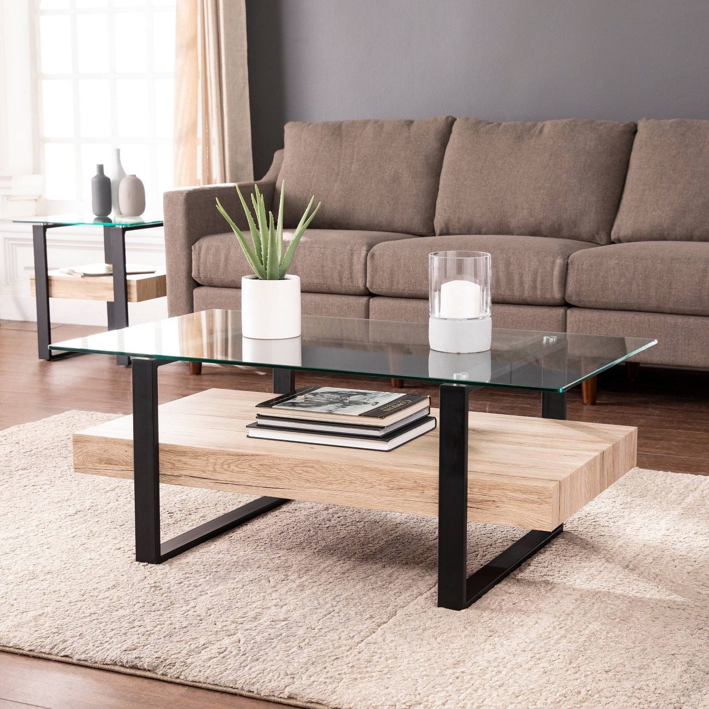 The natural wood, black hardware, and glass top table in a living room