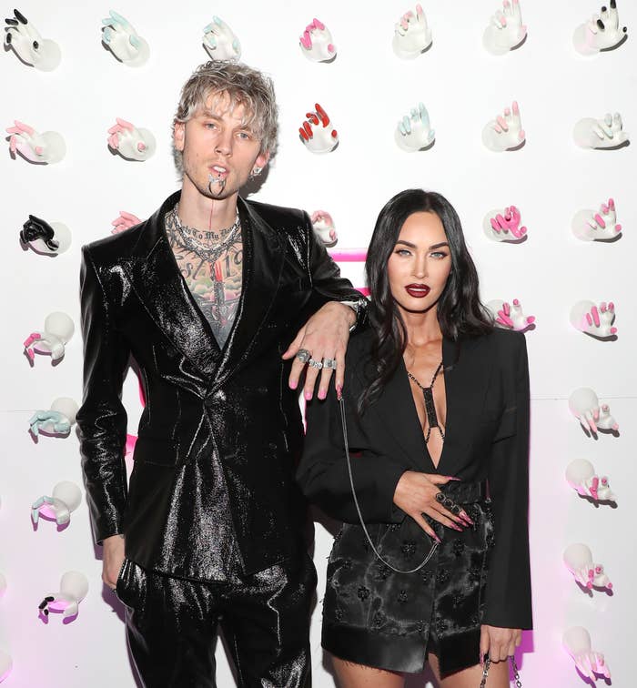 Machine Gun Kelly and Megan Fox stand next to each other on the red carpet