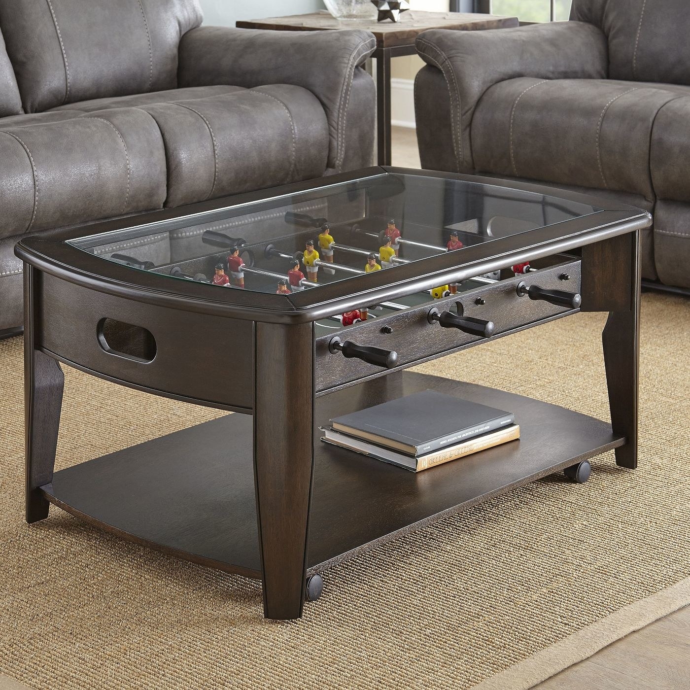 The dark brown coffee table with a foosball game built in under the glass