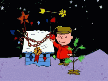 Charlie Brown decorating a Christmas tree