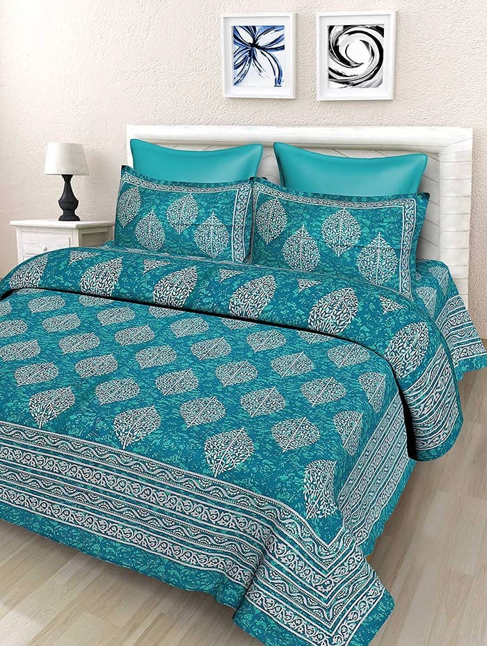 Sea green bedsheet on a bed
