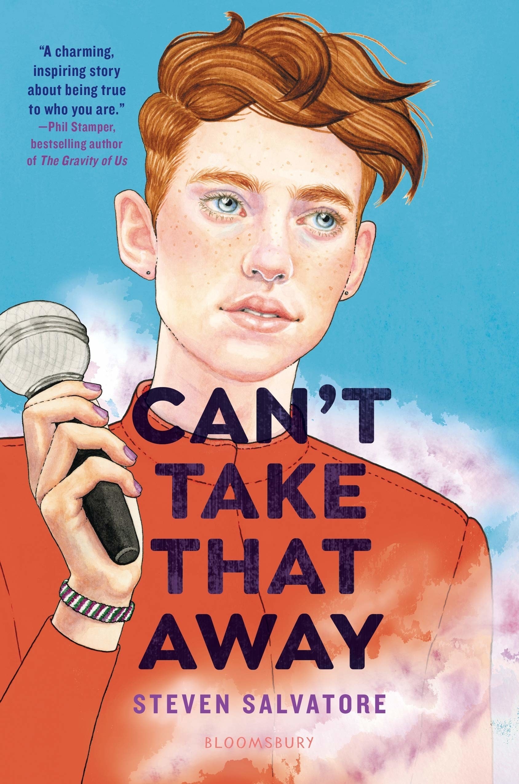A freckled redhead boy holds a microphone