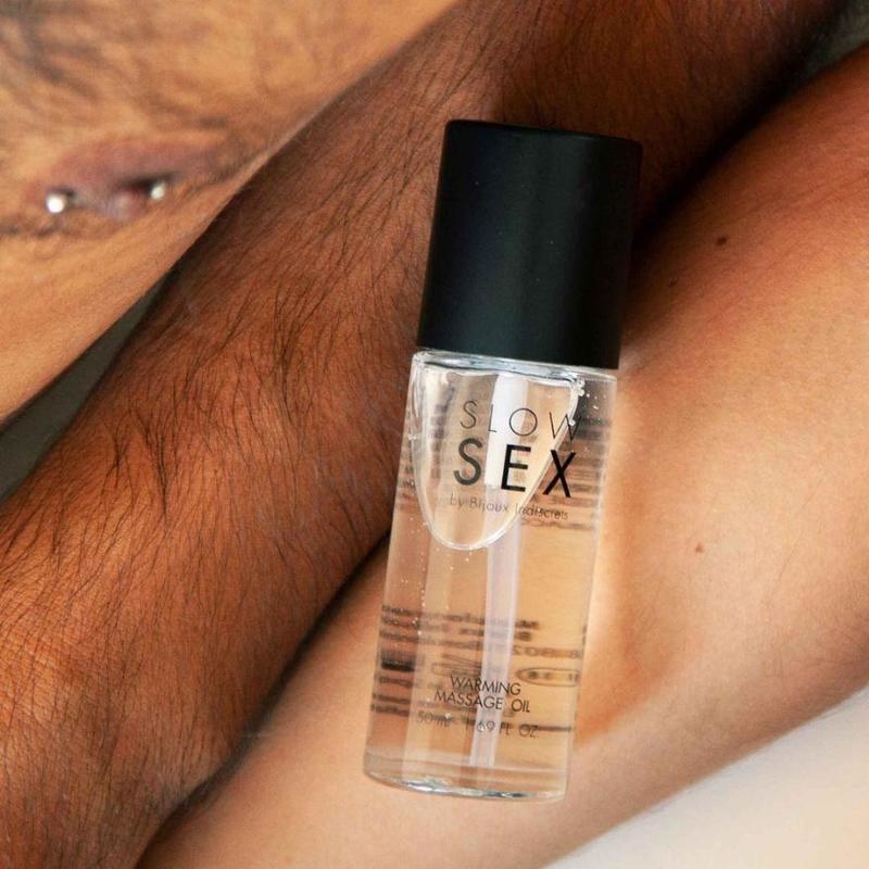 Models with a bottle of Slow Sex warming massage oil tomorrow