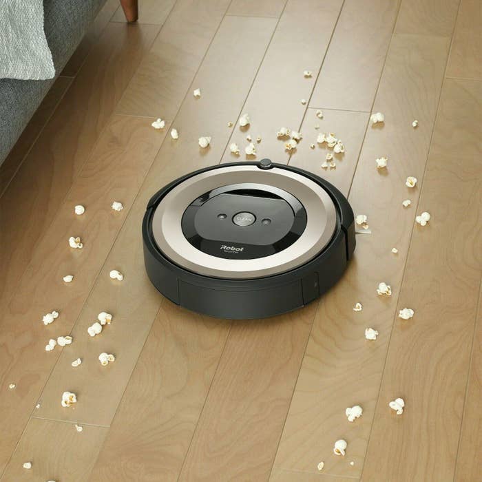 Vacuum cleaner on a hardwood floor, cleaning up popcorn