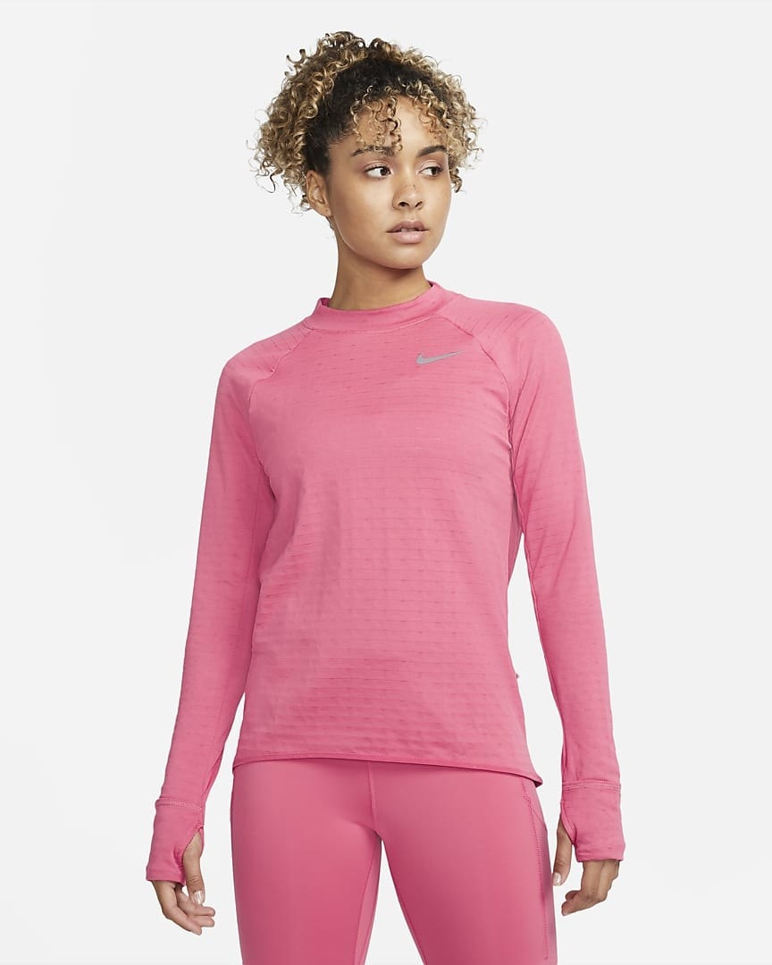 Model wearing the pink top with built-in mittens with thumbholes