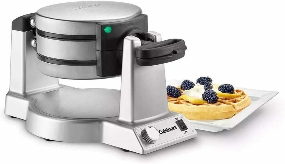 Waffle maker with a plate of waffles next to it