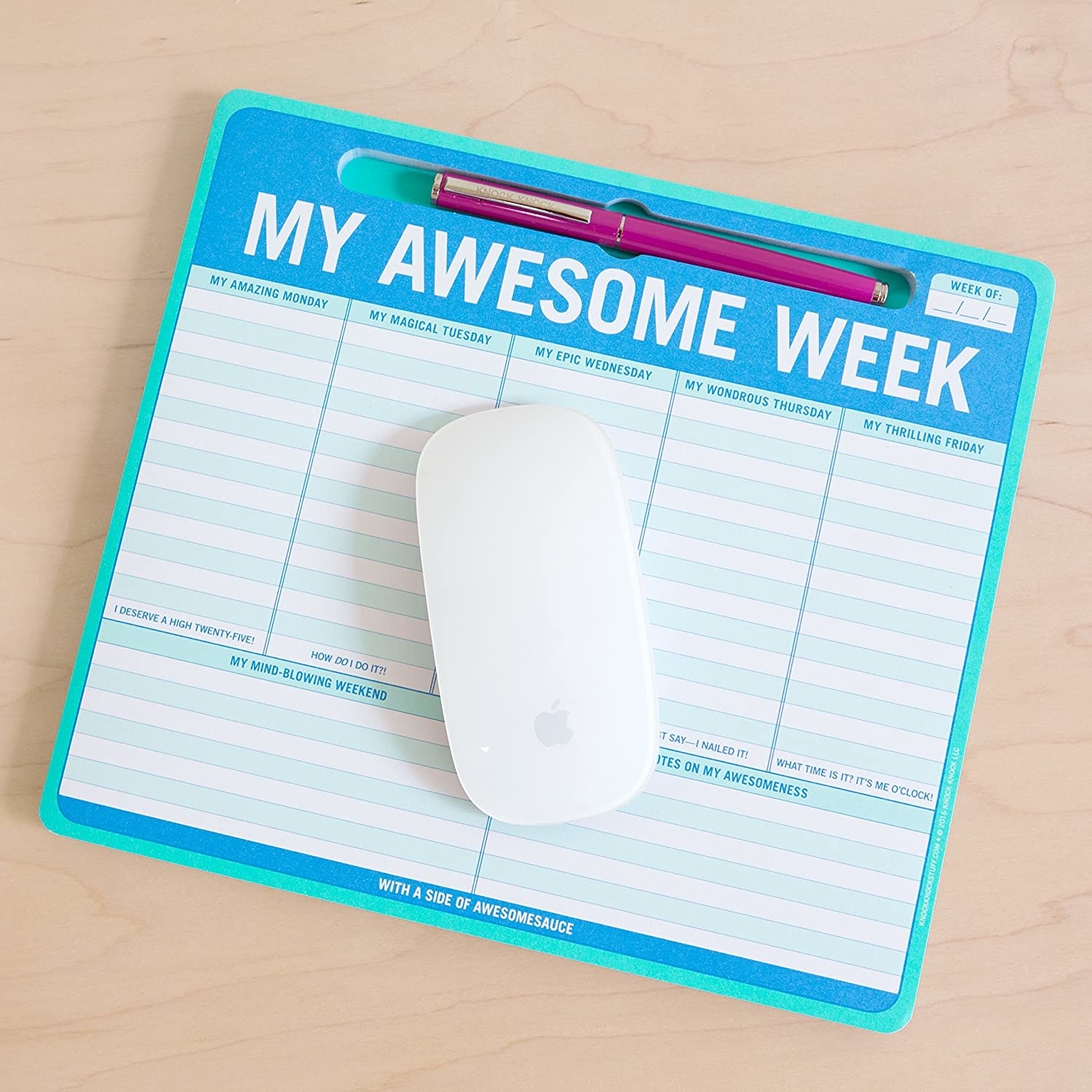 The mousepad on a desk with a mouse on it