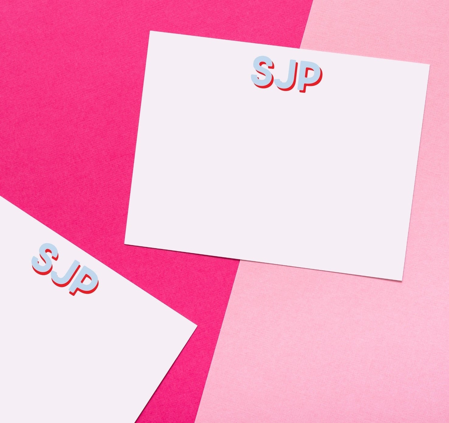 Two cards monogrammed with SJP in blue and red lettering