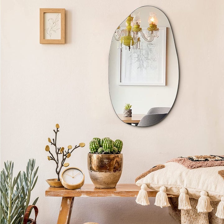 asymmetrical oval mirror on wall