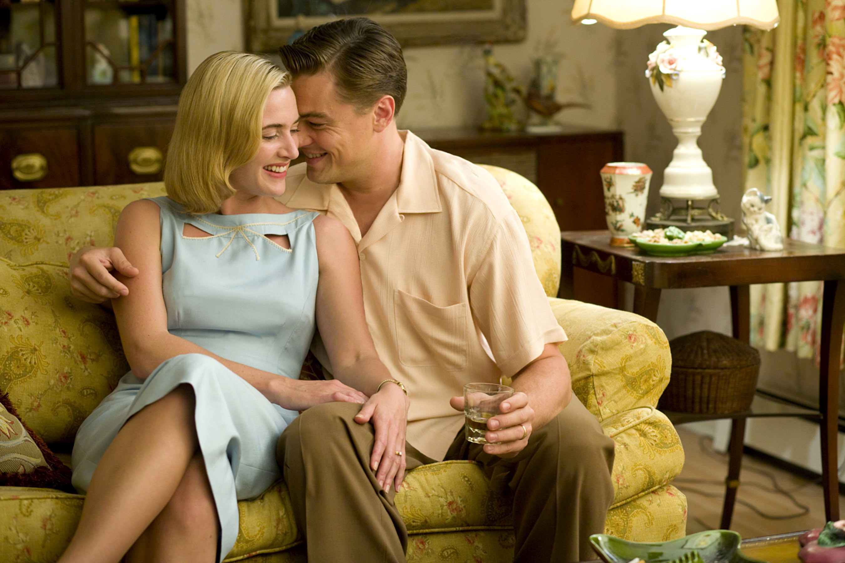 Kate Winslet and Leonardo DiCaprio sit together on a couch