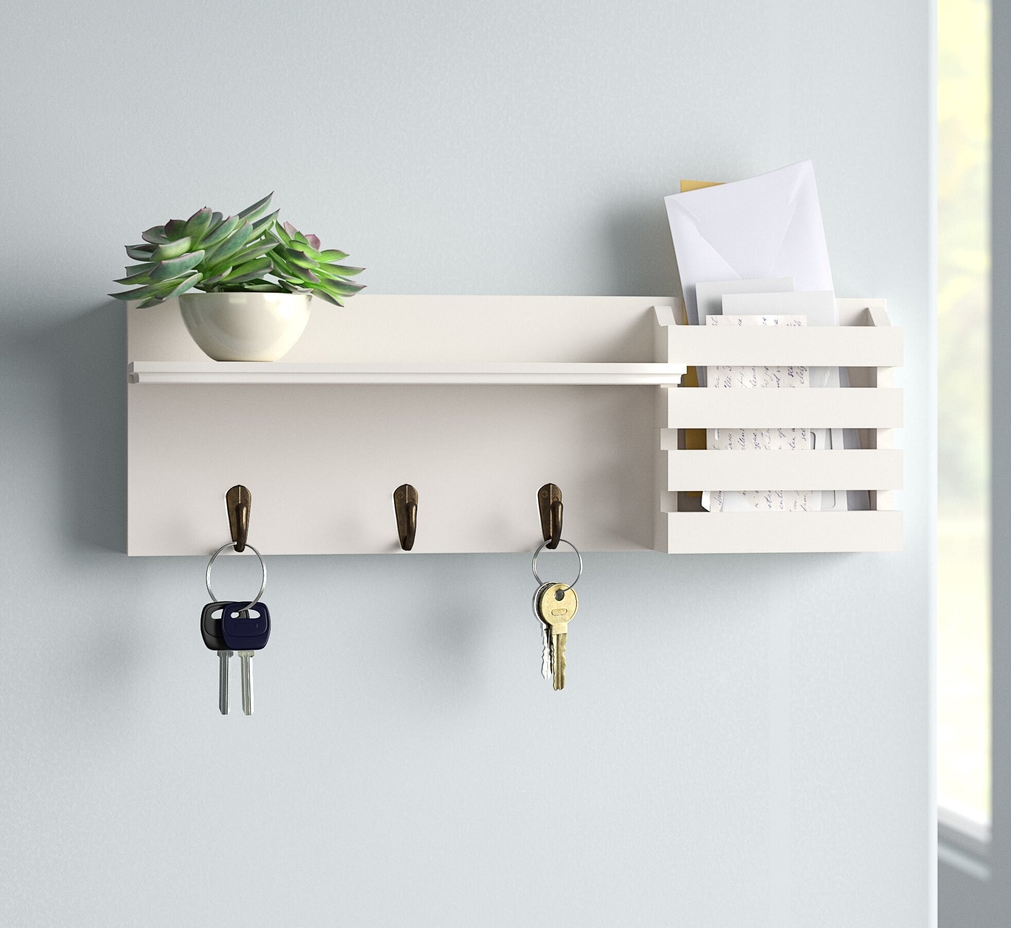 The white shelf on a wall holding keys, a succulent, and mail