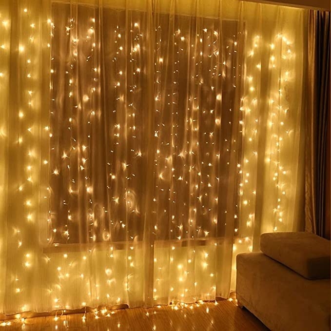 A window covered in curtain twinkle lights