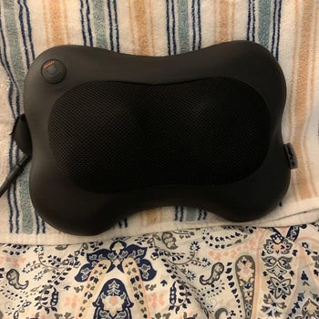 a reviewer photo of the black massage pillow