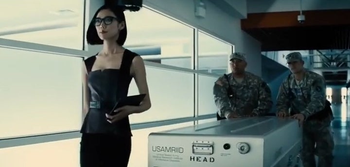 Mercy Graves walking with army soldiers down a hallways with a silver case in &quot;Batman v Superman: Dawn of Justice&quot;