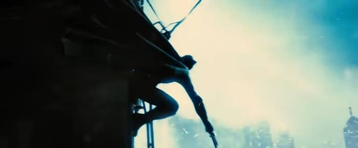 Batman hanging from the side of a building with lightning behind him in &quot;Batman v Superman: Dawn of Justice&quot;