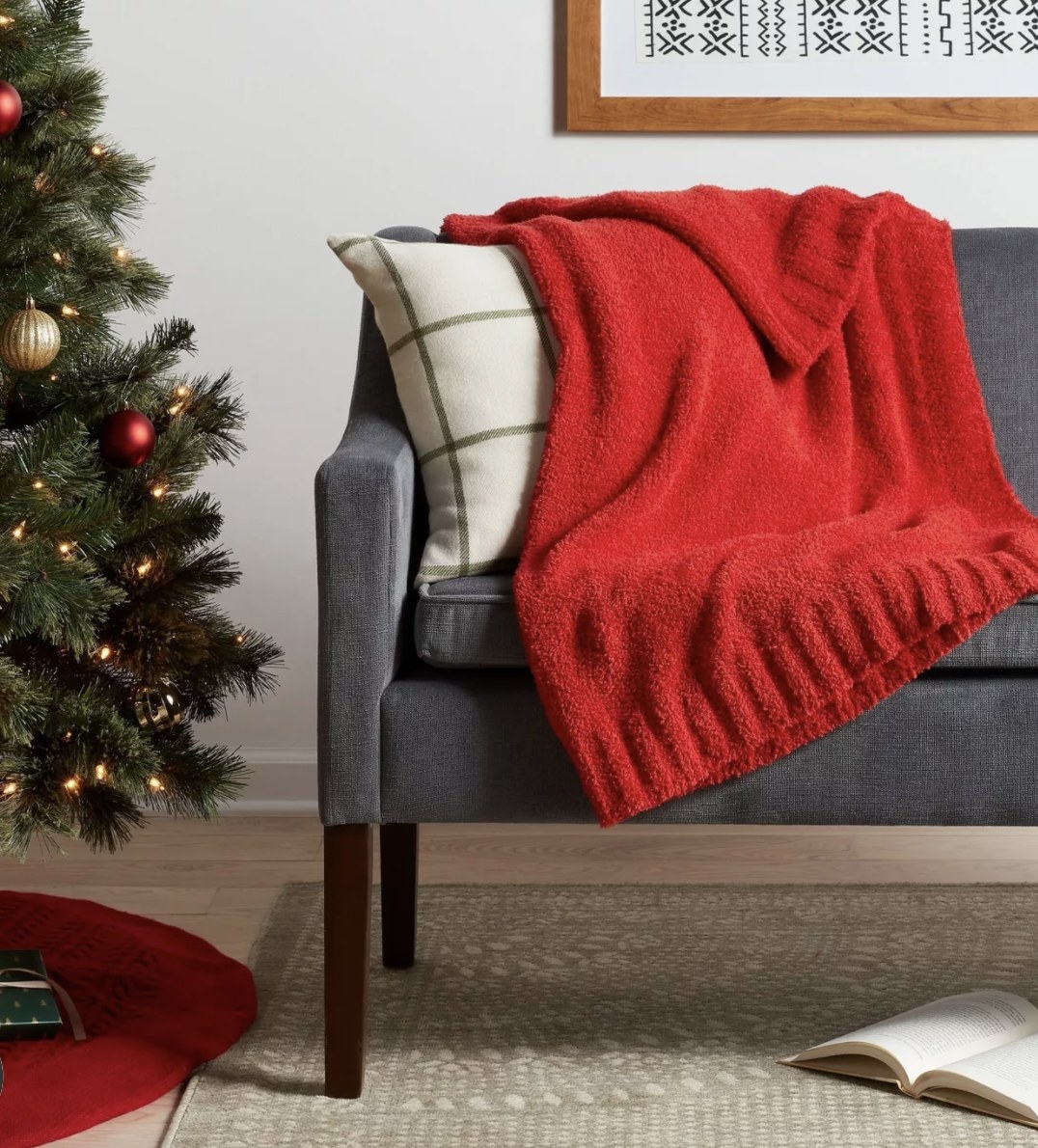 The bright red soft throw has a rubbed edge a heathered solid hue