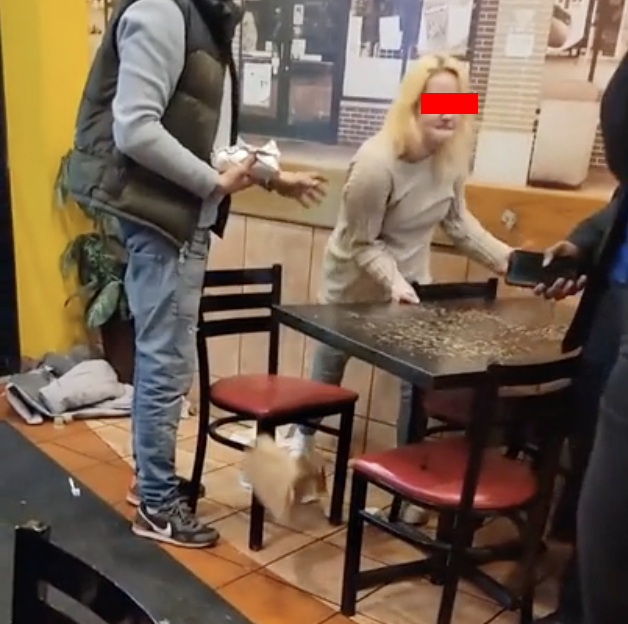 woman flipping a table inside of a restaurant