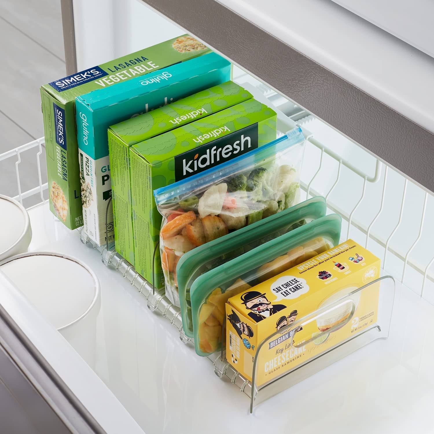 The freezer organizer with boxes and bags of food in it
