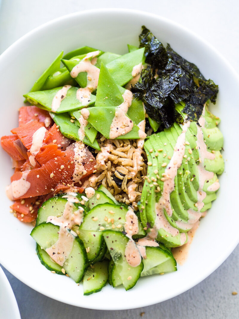 A smoked salmon, avocado, cucumber, and seaweed sushi bowl.