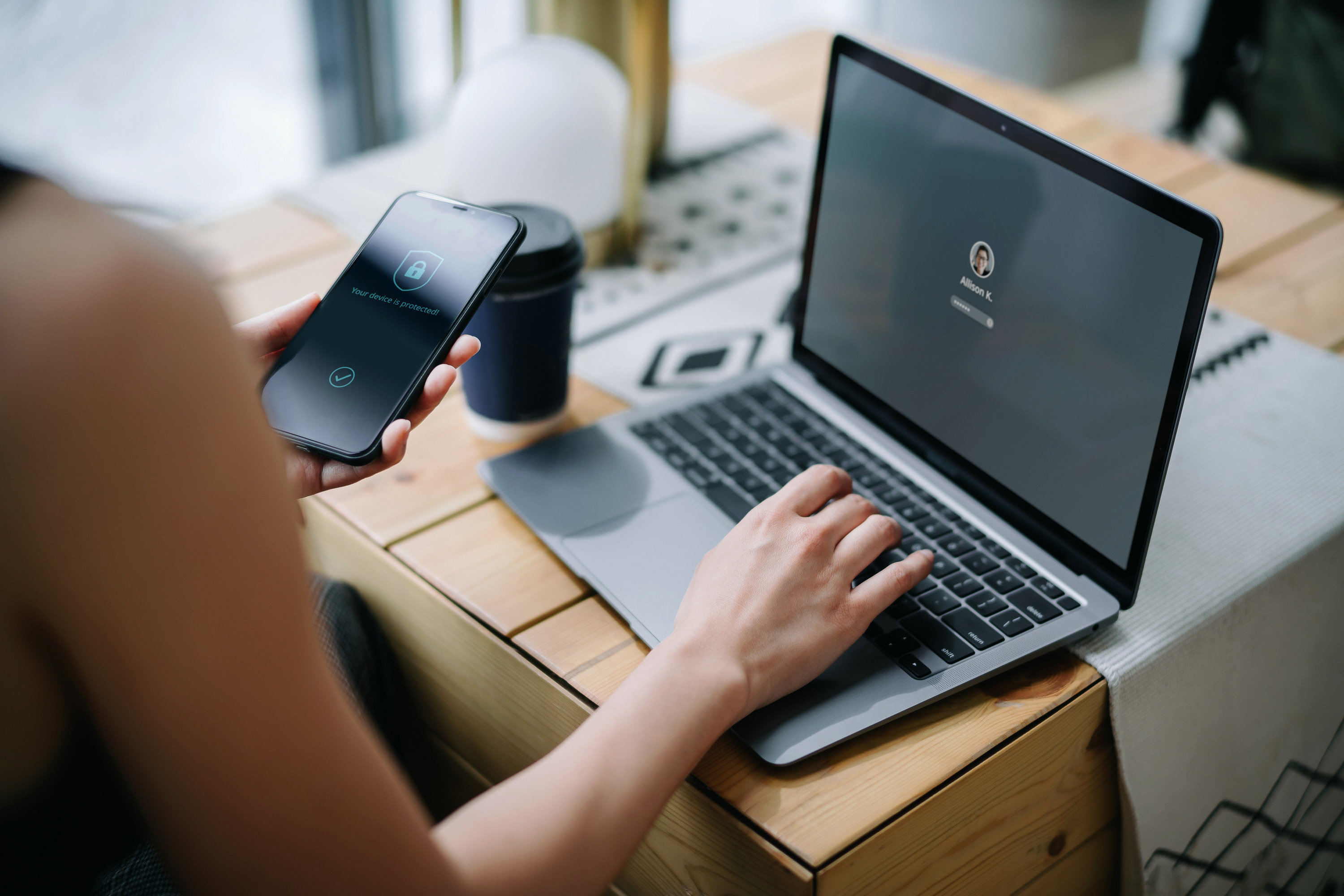 Person verifying their identity via their phone and computer