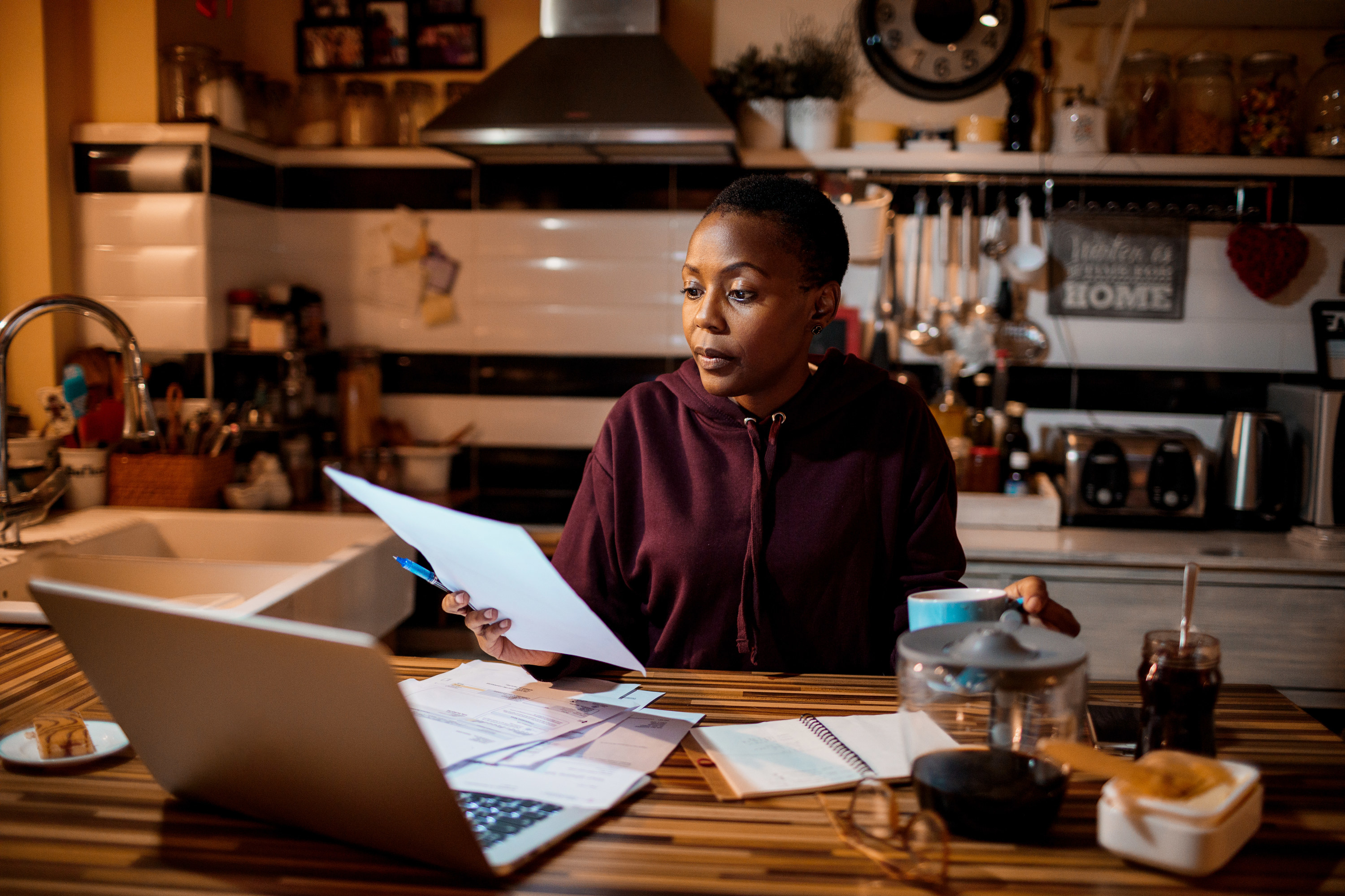 Woman going over her finances with her laptop at home