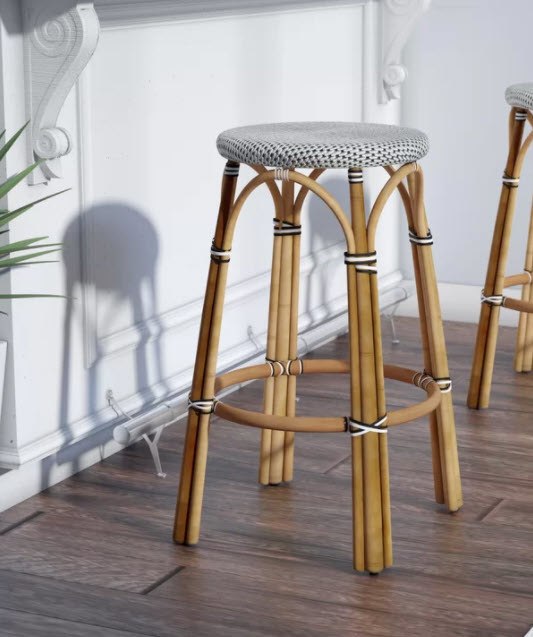 A bar or counter stool with a wicker frame and round seat made of woven plastic