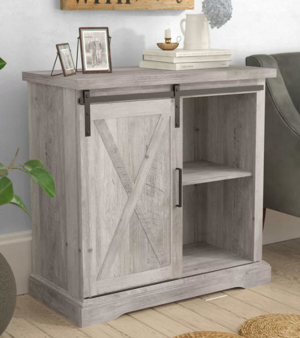 A farmhouse style rustic server and storage cabinet with two open shelves on the right and a door with handle on the left