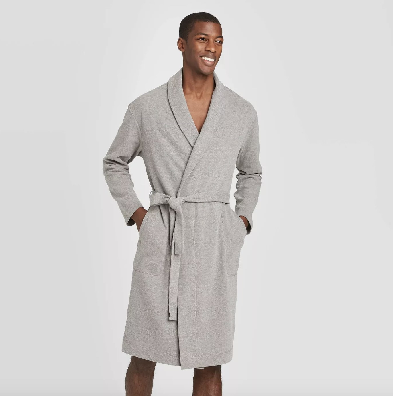 An adult is wearing a grey terry robe