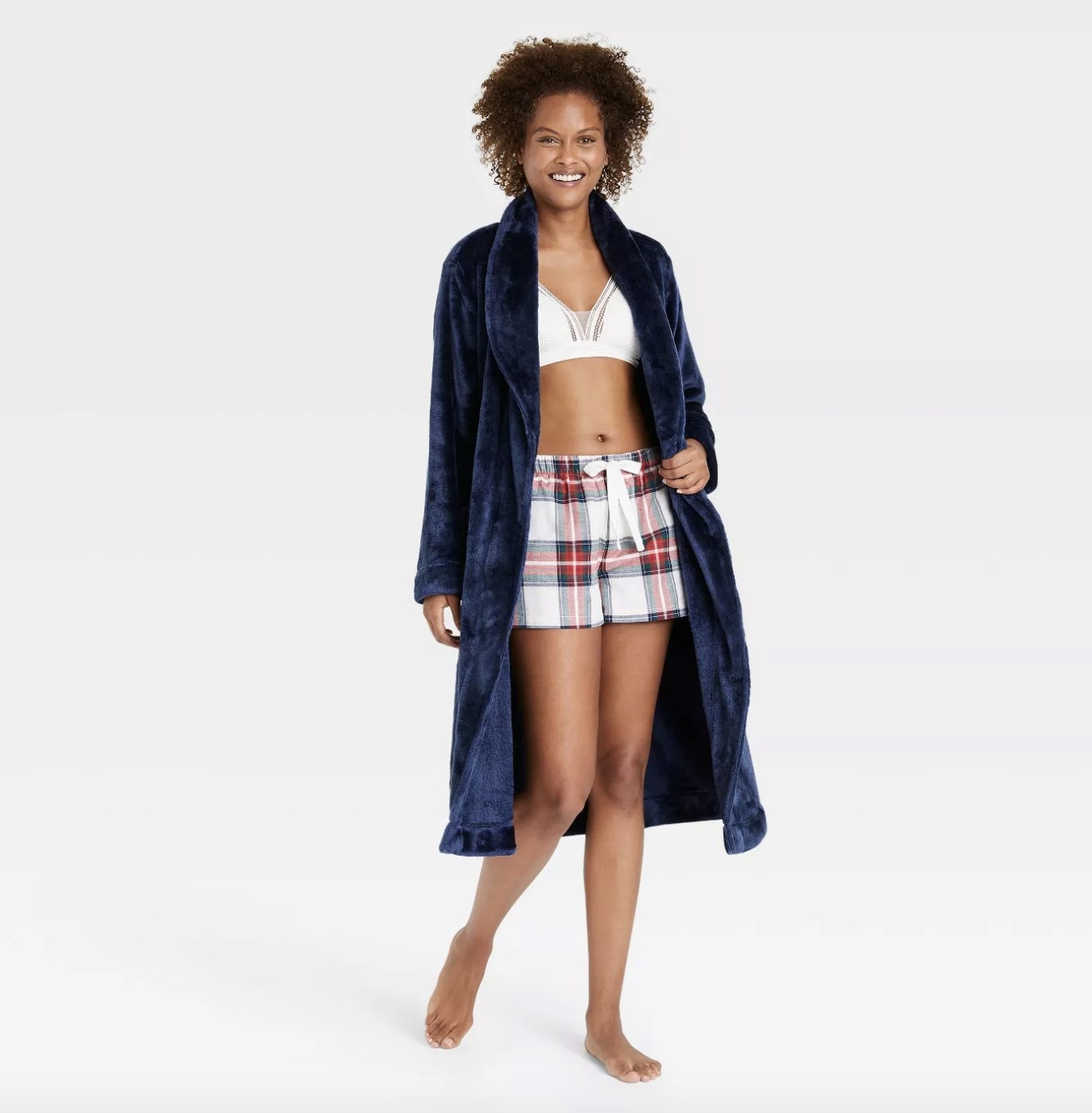 An adult wears crushed blue velvet robe with a bralette and pajama short set