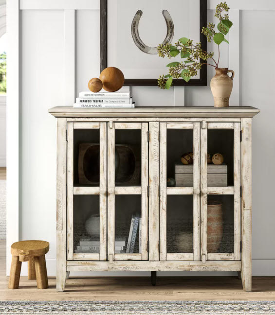 A 4-door glass accent cabinet with ample storage space and open-facing cabinets in a  rustic and distressed wood style