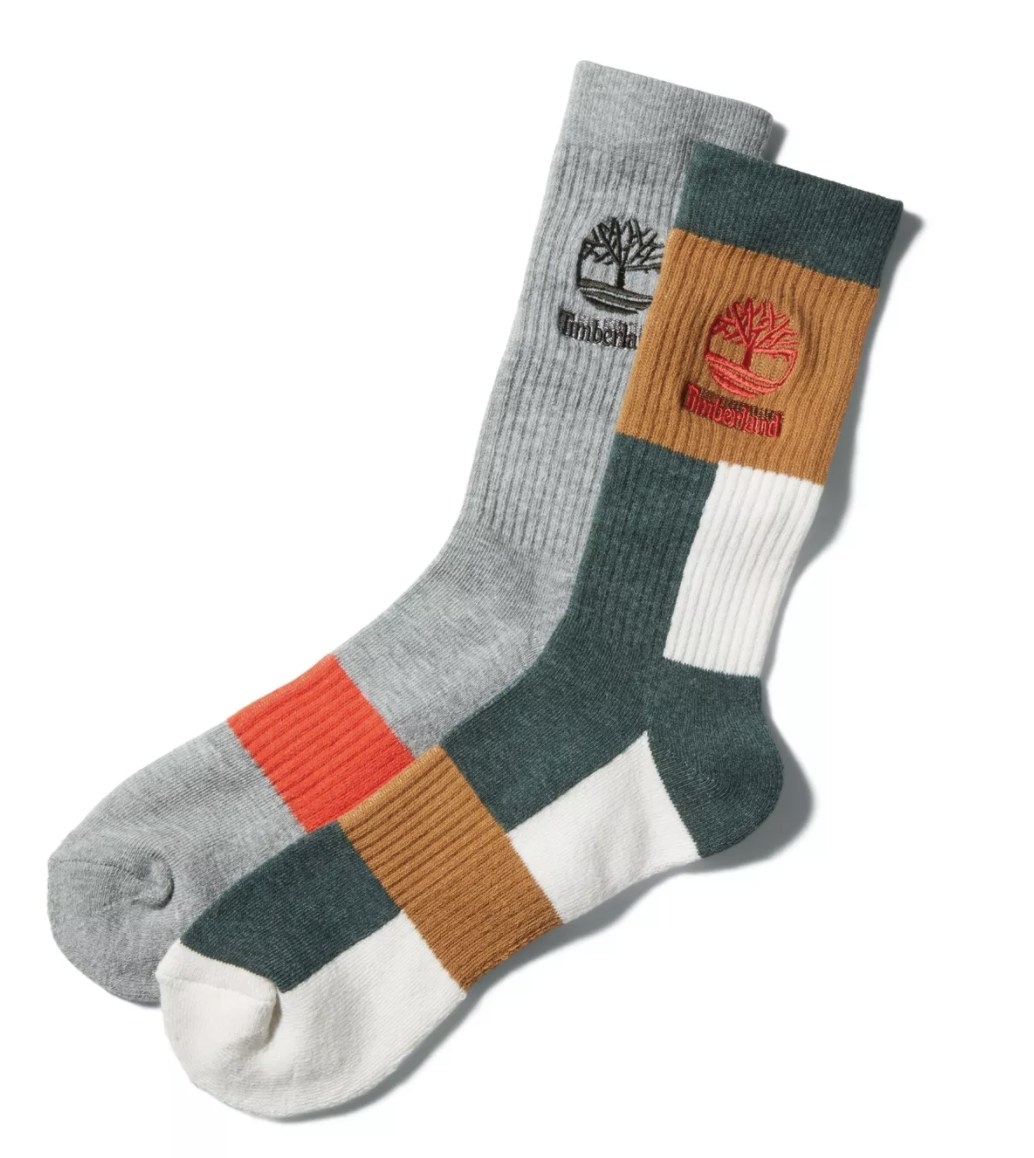 There is a grey sock with an orange stripe and a green, white and brown sock