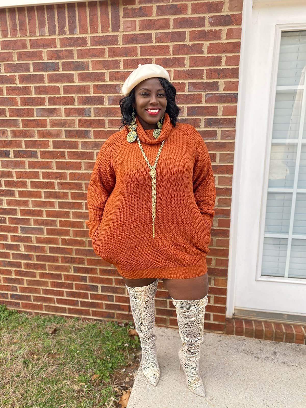 a reviewer wears the rust-colored dress