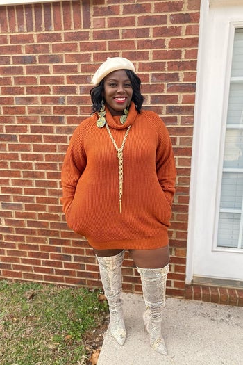 a reviewer wears the rust-colored dress