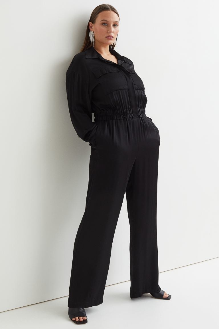 a model wears the long sleeve jumpsuit in black
