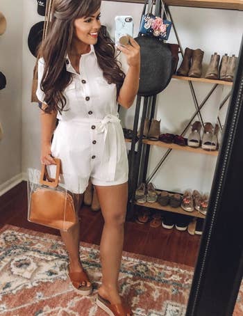 a reviewer poses for a mirror selfie in the white romper