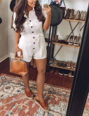 a reviewer poses for a mirror selfie in the white romper