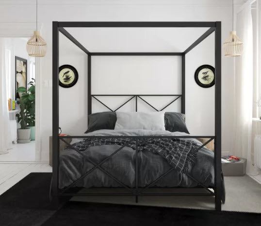 A canopy bed with metal framing and a criss-cross design headboard
