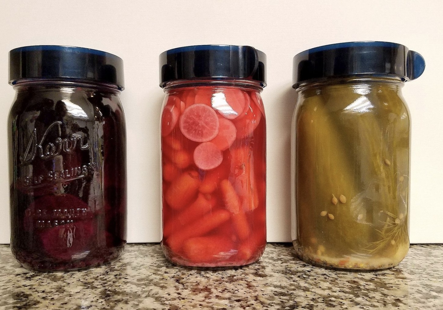 three jars of pickled foods