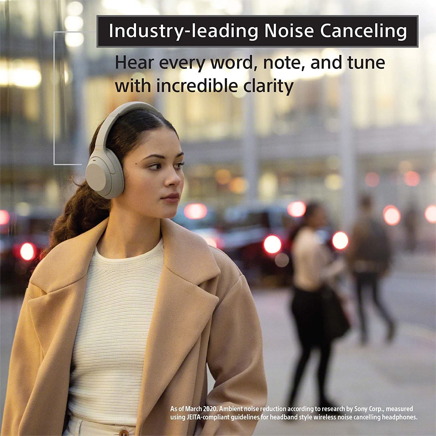 A woman walking with the noise cancellation headphones on
