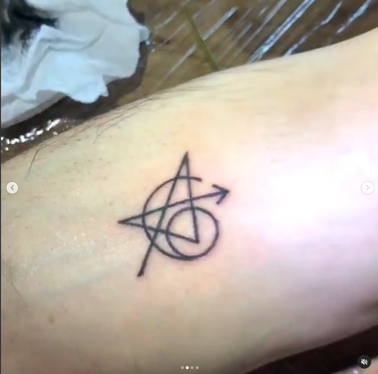 the tattoo is a combination of an A, an arrow, and a 6