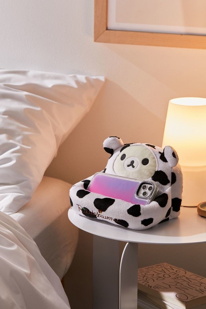 soft phone holder shaped like a cow-print couch