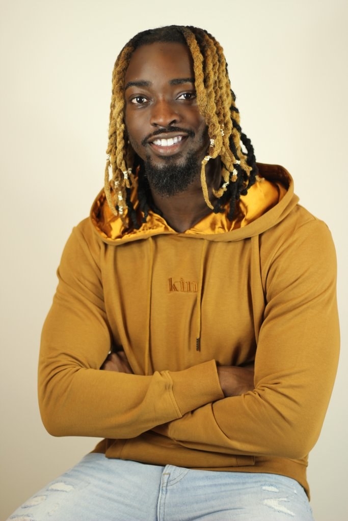 a model wearing the gold hoodie
