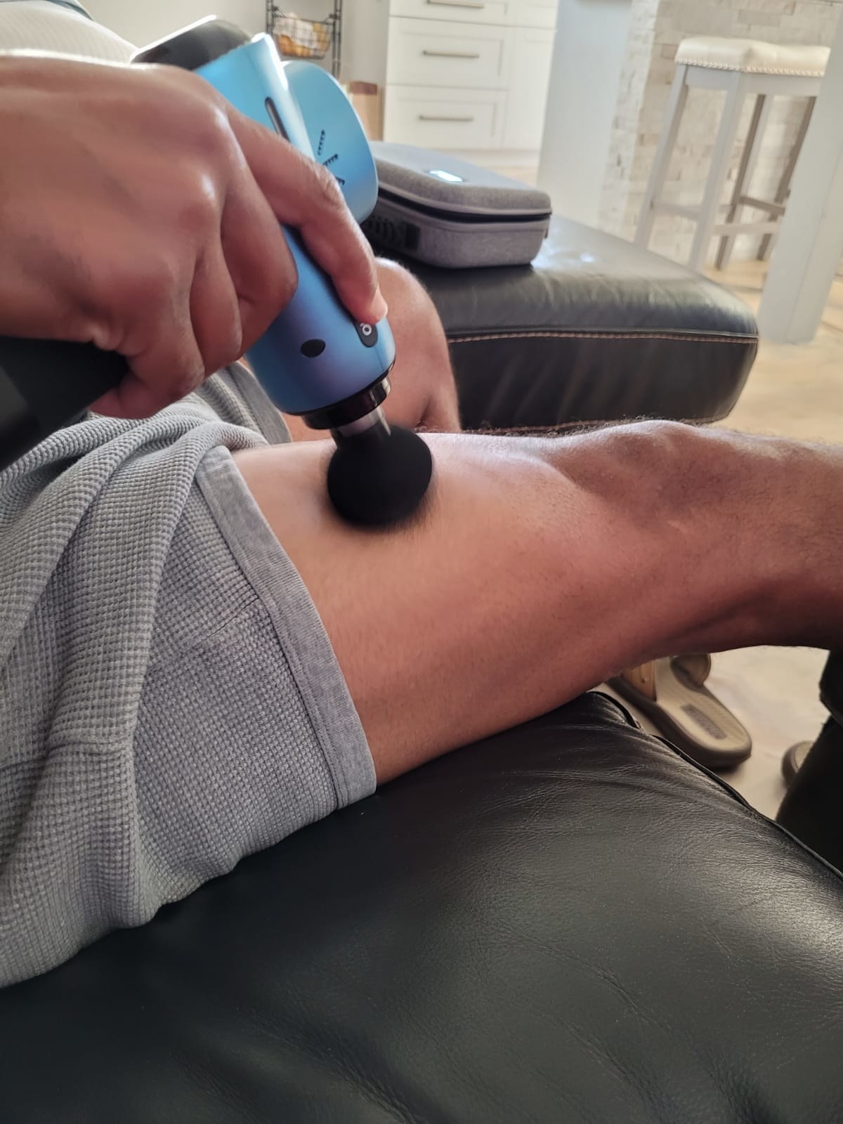 A reviewer using the round attachment on their thigh